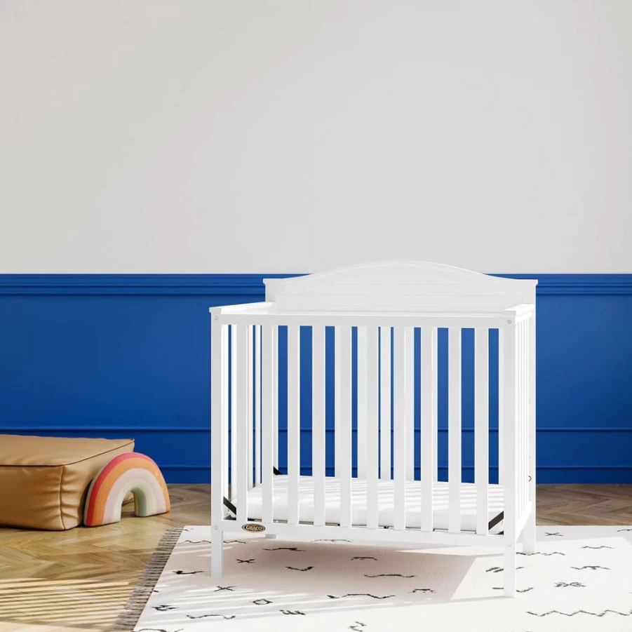 Graco Stella 4-in-1 Convertible Mini Crib with Mattress – Converts to Twin Bed, Includes Water-Resistant Cover, Headboard & Footboard, Pebble Gray